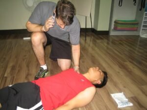 Calling for help before rescuing the victim with First Aid Training Mississauga